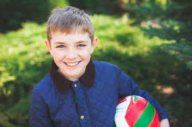 child smiling with ball