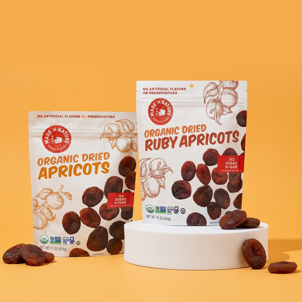 Two packages of Organic Dried Apricots on a yellow background