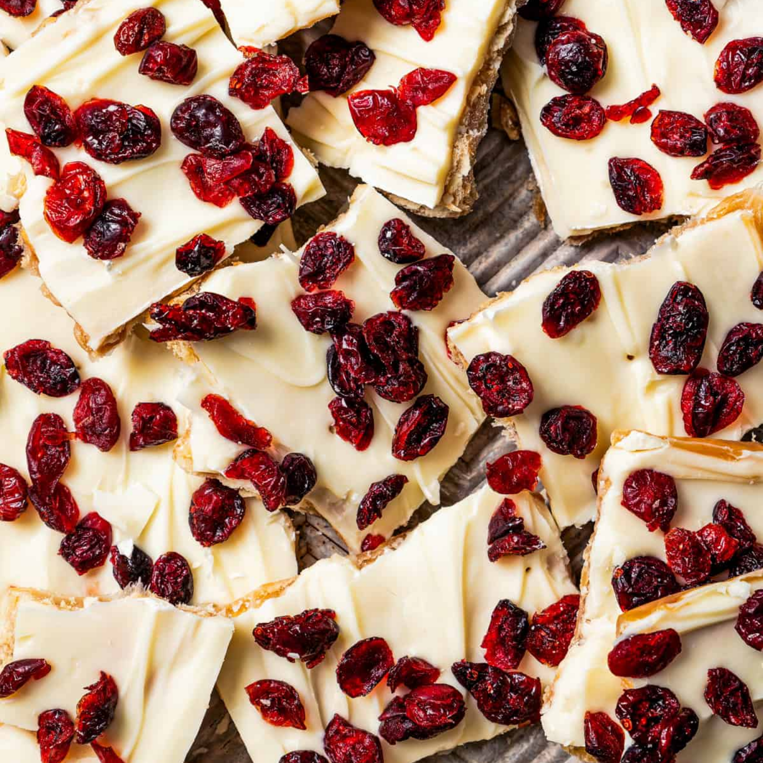 White chocolate bars with cranberries on a wooden surface