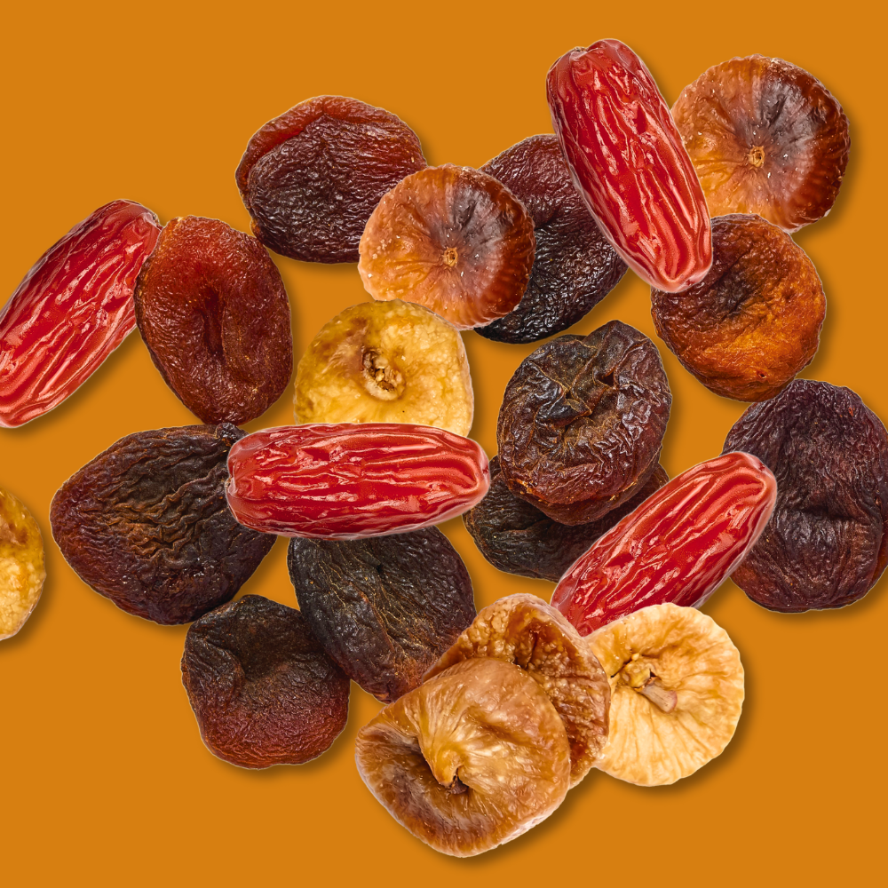 Assorted dried figs on a yellow background