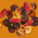 Assorted dried figs on a yellow background